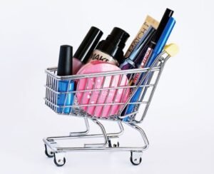 drain-cleaning Miniature shopping cart filled with a variety of cosmetics on a white background.
