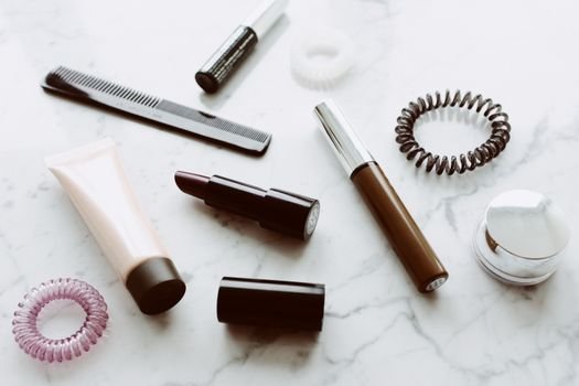 commercial-plumbing Top view of various cosmetic products for making up hair brush hair elastic bands placed on white background with marble pattern